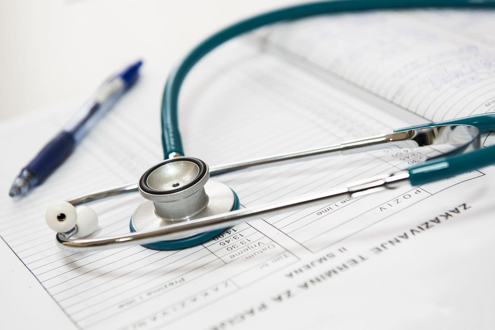 Doctors standing together reviewing patient data on a tablet
