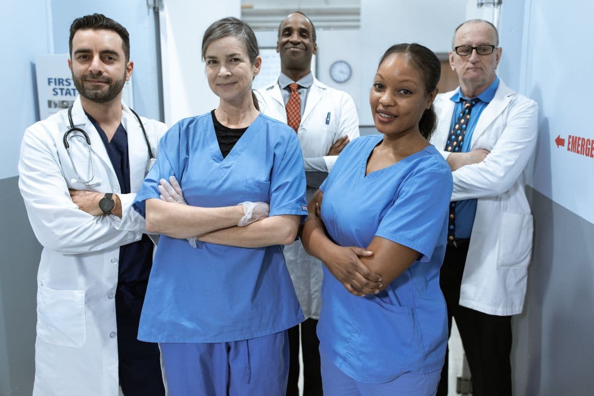 Nurse and physician standing together in a clinic hallway